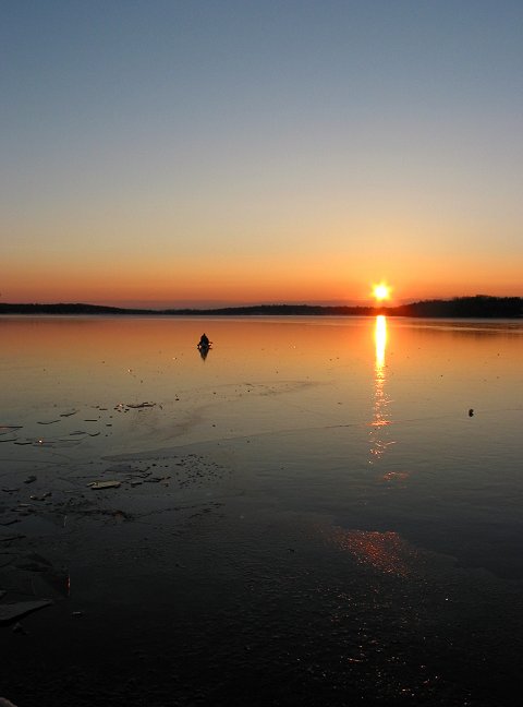 Sunset and canoe on frozen Upper South Long Lake, Brainerd, Minnesota
