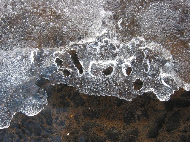 Melting ice over asphalt, Chantilly, Virginia