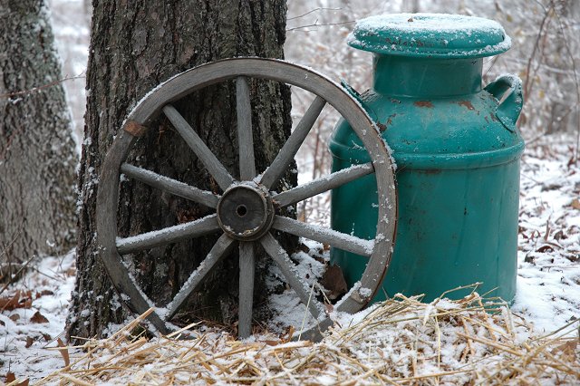 Wood wheel and jug in snow, Brainerd, Minnesota